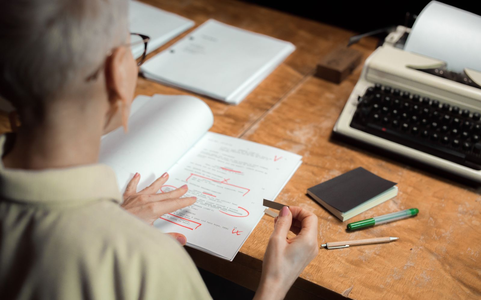 An editor marking up a manuscript by hand